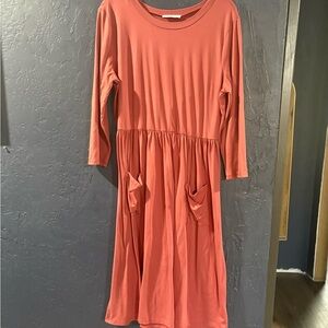 Beautiful rose colored dress with pockets on the front.